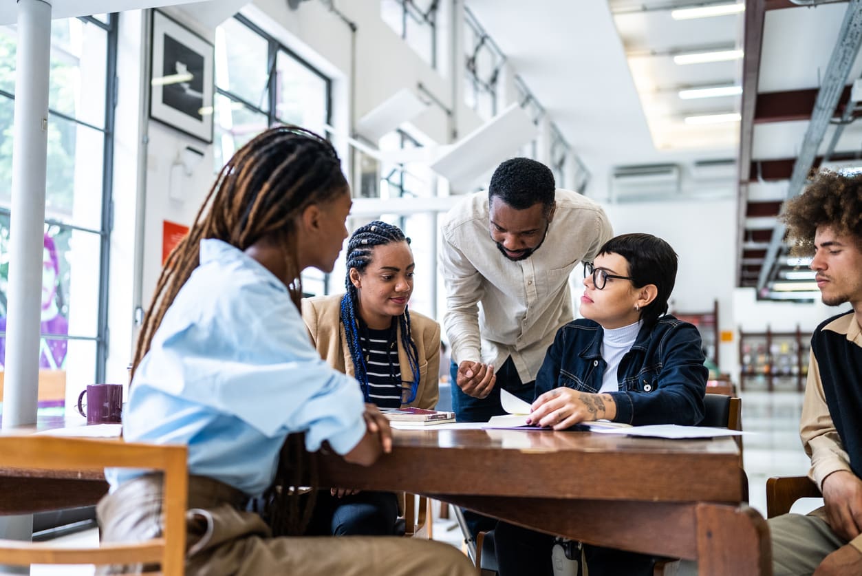 Teacher helping students in the library
